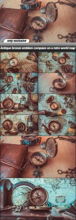 Antique bronze emblem compass on a retro world map